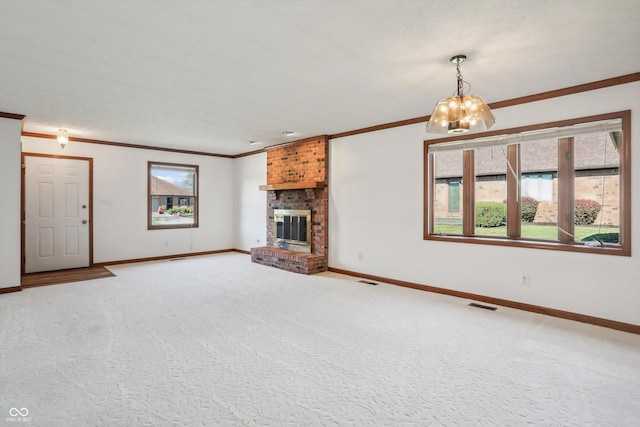 unfurnished living room featuring crown molding, baseboards, a fireplace, carpet flooring, and a chandelier