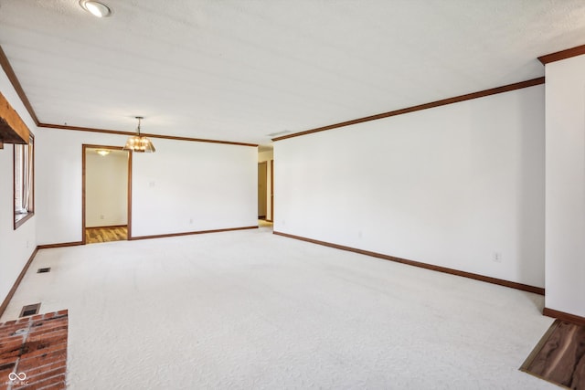 unfurnished living room featuring ornamental molding, carpet floors, baseboards, and a chandelier