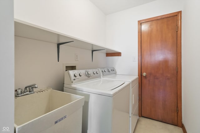 laundry area with washer and dryer and sink