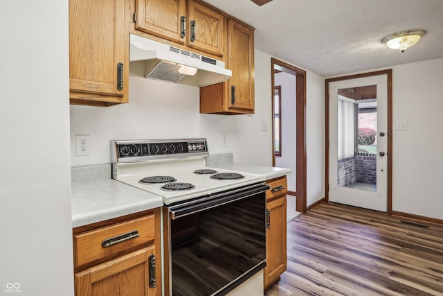 kitchen featuring white electric range, a textured ceiling, and light hardwood / wood-style flooring