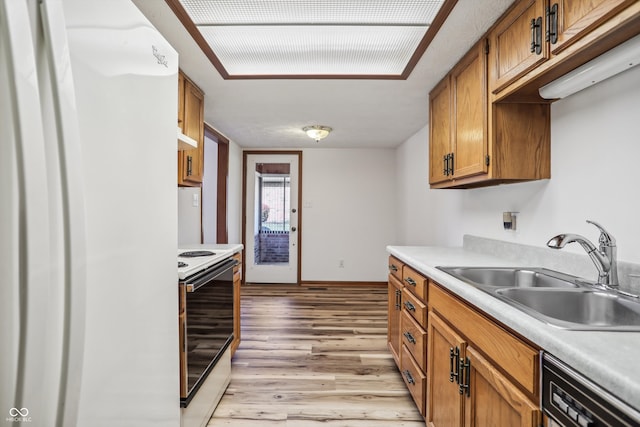 kitchen featuring sink, light hardwood / wood-style flooring, and white appliances