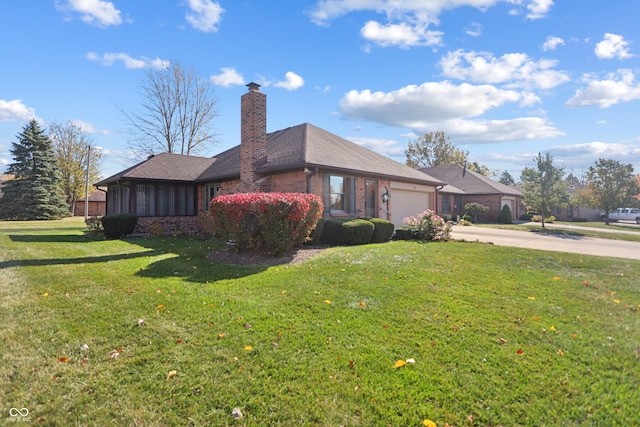 view of side of home featuring a yard and a garage