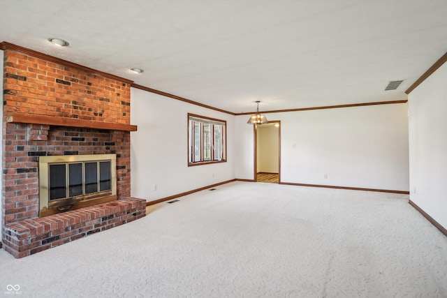 unfurnished living room with a fireplace, baseboards, crown molding, carpet flooring, and a chandelier
