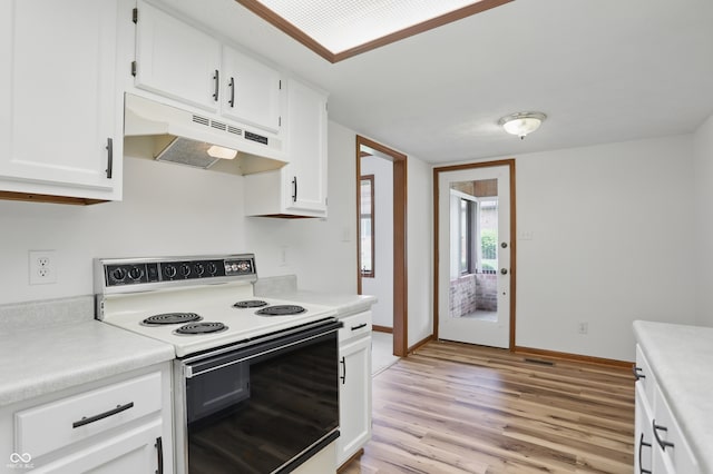 kitchen with range with electric stovetop, under cabinet range hood, light wood-style flooring, white cabinetry, and light countertops
