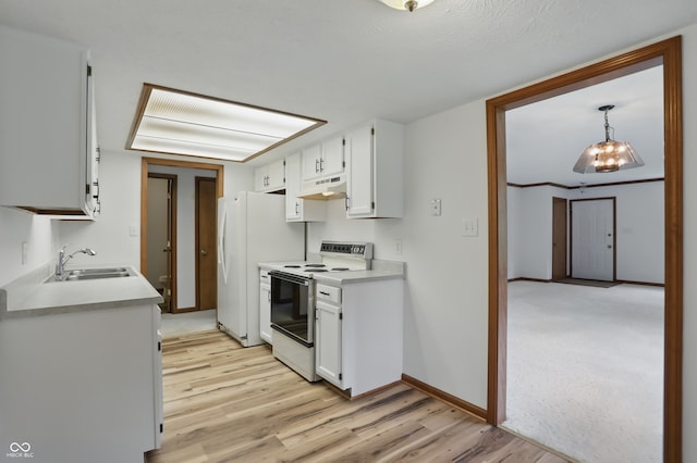 kitchen featuring electric range, a sink, under cabinet range hood, light wood finished floors, and light countertops