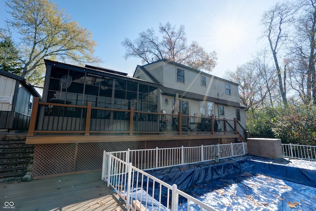 rear view of house featuring a swimming pool side deck and a sunroom