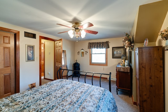 carpeted bedroom featuring baseboard heating and ceiling fan