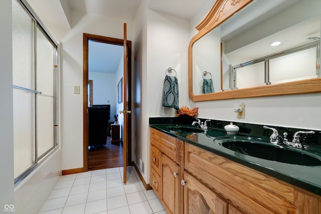 bathroom featuring vanity, enclosed tub / shower combo, and tile patterned flooring