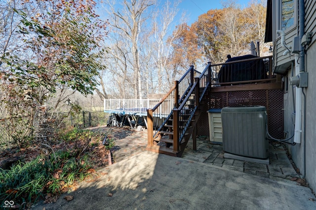 view of yard featuring a wooden deck, cooling unit, and a patio area