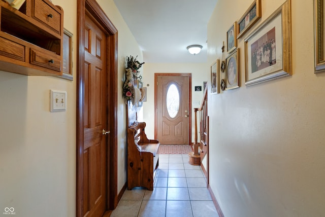 doorway to outside featuring light tile patterned flooring