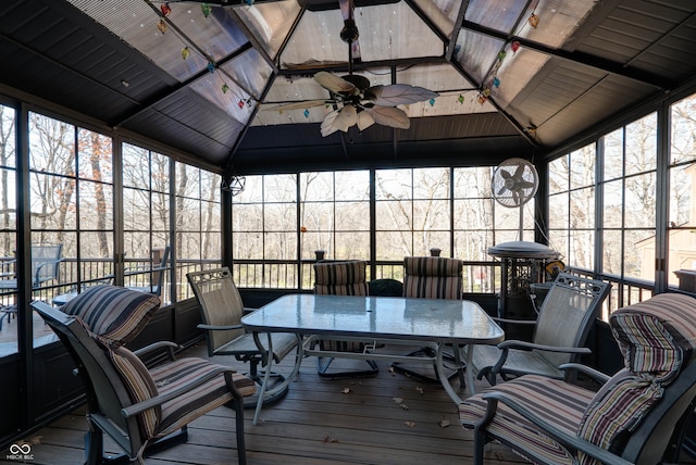 sunroom / solarium with lofted ceiling and ceiling fan