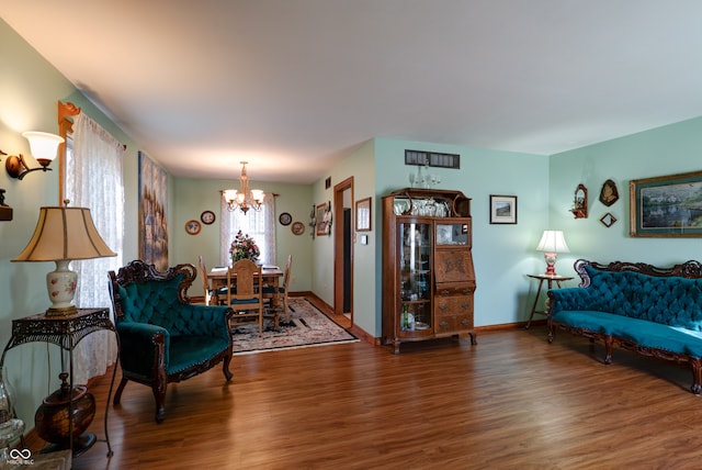 living room with a notable chandelier and dark hardwood / wood-style floors