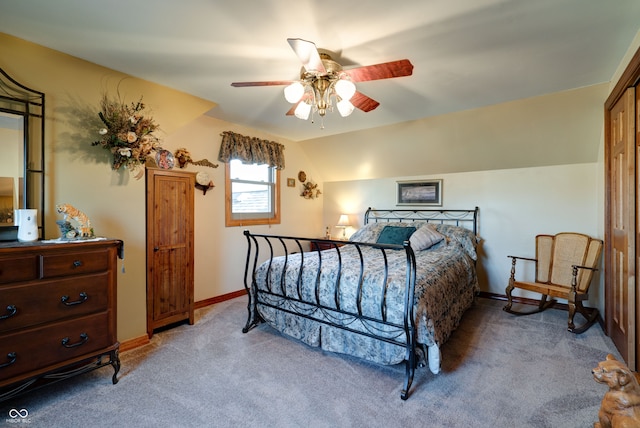 carpeted bedroom featuring ceiling fan and vaulted ceiling