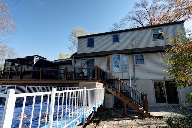 rear view of house featuring a wooden deck