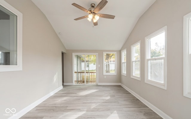 unfurnished sunroom with a wealth of natural light, lofted ceiling, and ceiling fan