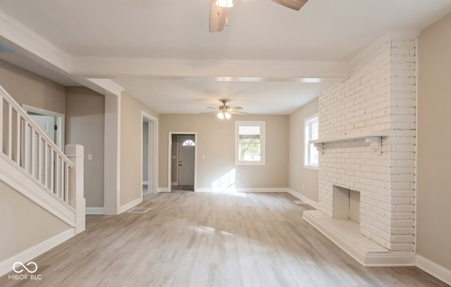 unfurnished living room with ceiling fan, light hardwood / wood-style flooring, and a brick fireplace