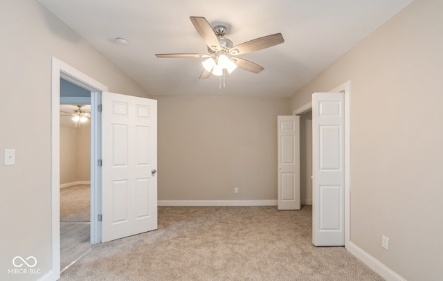 unfurnished bedroom featuring light colored carpet and ceiling fan