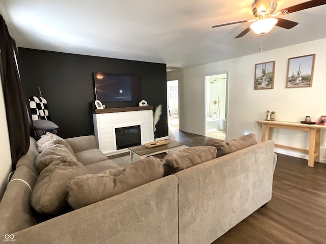 living room with ceiling fan and dark hardwood / wood-style flooring