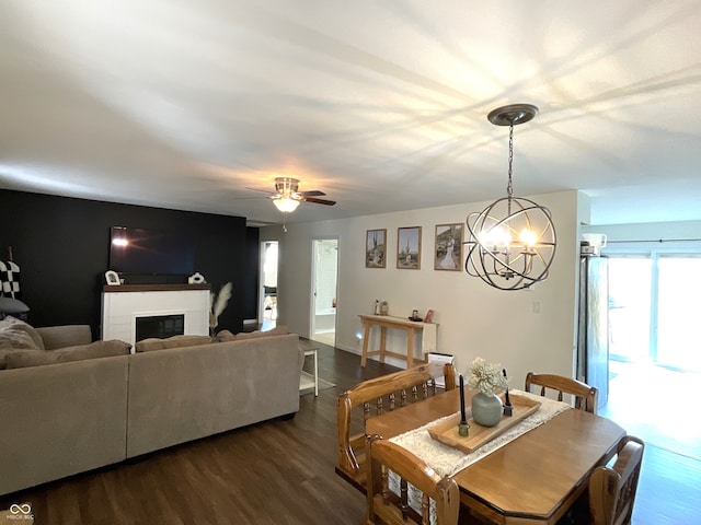 dining space featuring hardwood / wood-style flooring and ceiling fan with notable chandelier