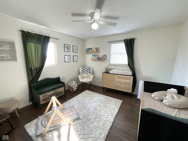 living area with dark wood-type flooring and ceiling fan