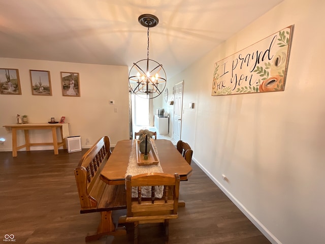 dining area featuring an inviting chandelier and dark hardwood / wood-style flooring