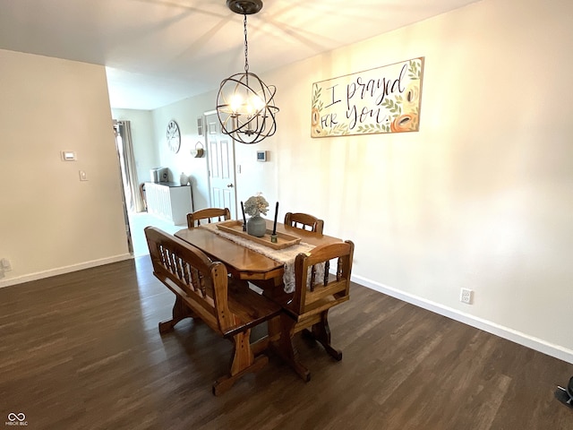 dining room with dark wood-type flooring and an inviting chandelier