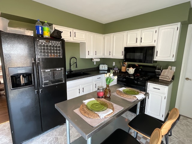 kitchen with black appliances, sink, and white cabinets