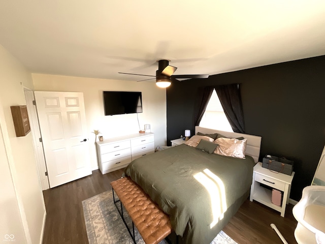 bedroom with dark hardwood / wood-style floors and ceiling fan