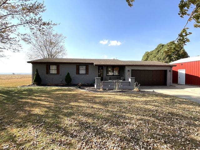 ranch-style house featuring a front yard and a garage