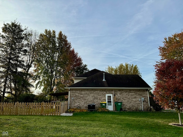 view of side of home featuring a yard and central air condition unit