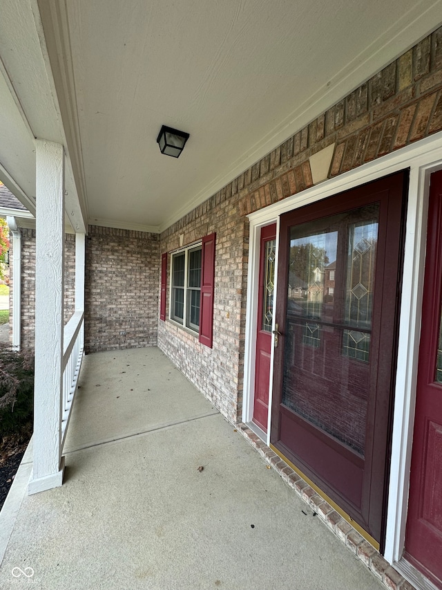 view of exterior entry with a porch