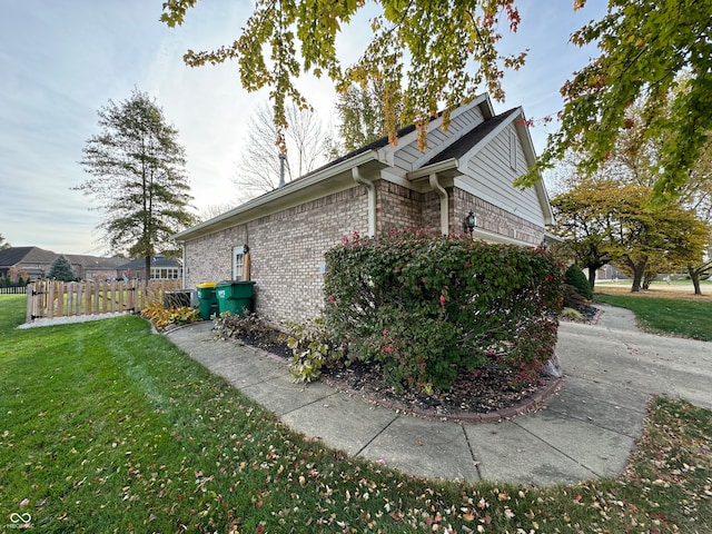 view of side of home with a yard