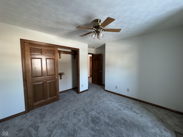 unfurnished bedroom with ceiling fan, carpet floors, a textured ceiling, and a closet