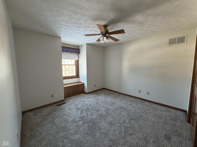 empty room with a textured ceiling, ceiling fan, and carpet flooring