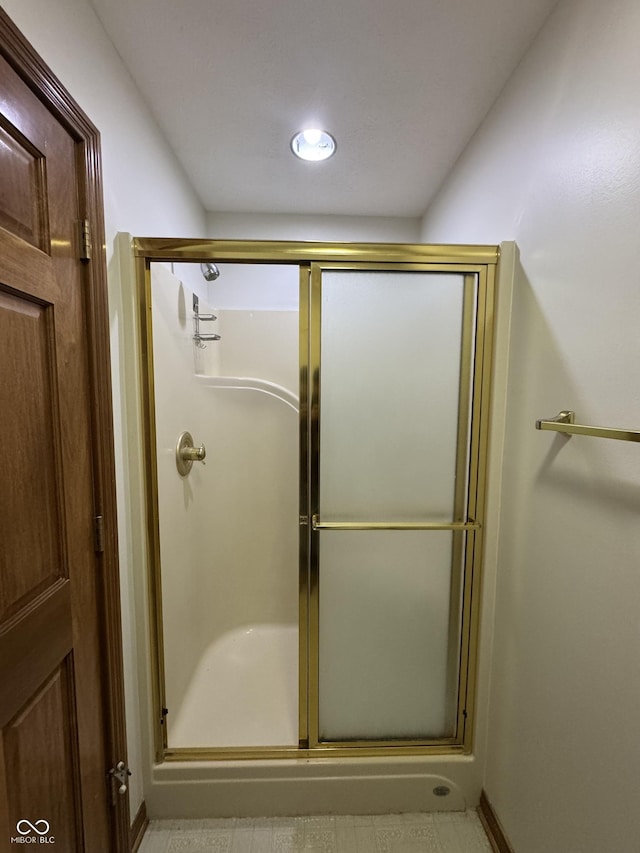 bathroom with a shower with shower door