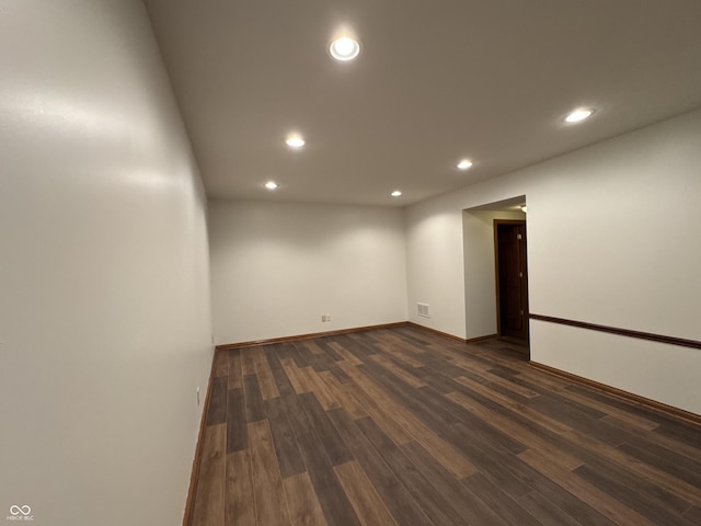 unfurnished room featuring dark wood-type flooring