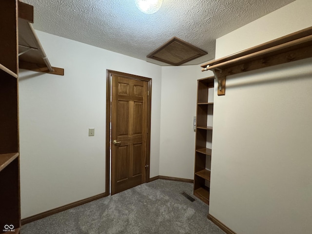 spacious closet featuring dark colored carpet