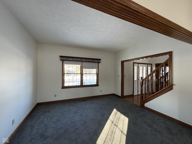 carpeted spare room with a textured ceiling