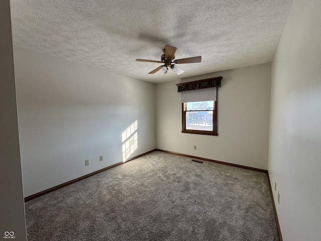 spare room with ceiling fan, carpet floors, and a textured ceiling