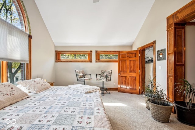 bedroom featuring light carpet and vaulted ceiling