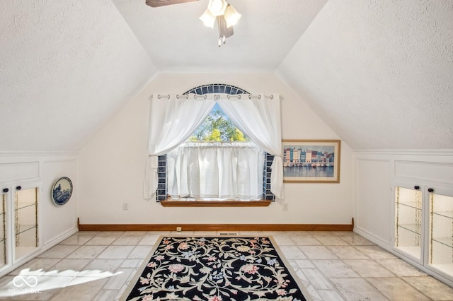 6902 Creekridge Trl, Indianapolis, IN 46256 - bonus room featuring a textured ceiling, vaulted ceiling, ceiling fan, and baseboards