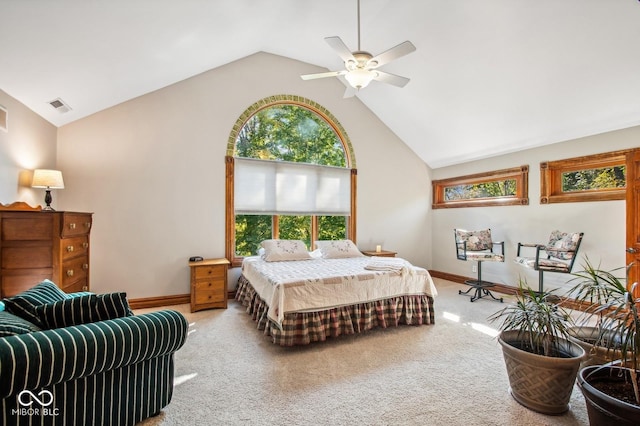 carpeted bedroom with ceiling fan and high vaulted ceiling