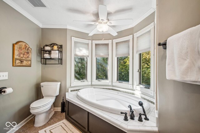 bathroom featuring ceiling fan, tile patterned floors, crown molding, toilet, and a bathtub