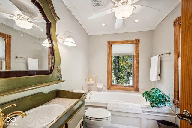 bathroom with crown molding, a bathtub, vanity, and toilet