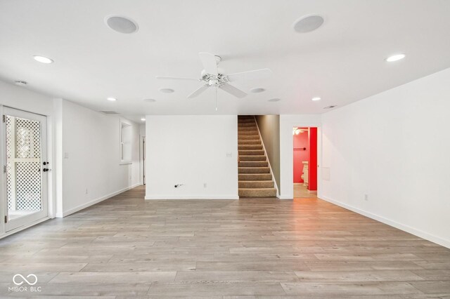 6902 Creekridge Trl, Indianapolis, IN 46256 - unfurnished room with recessed lighting, baseboards, stairs, a ceiling fan, and light wood-type flooring