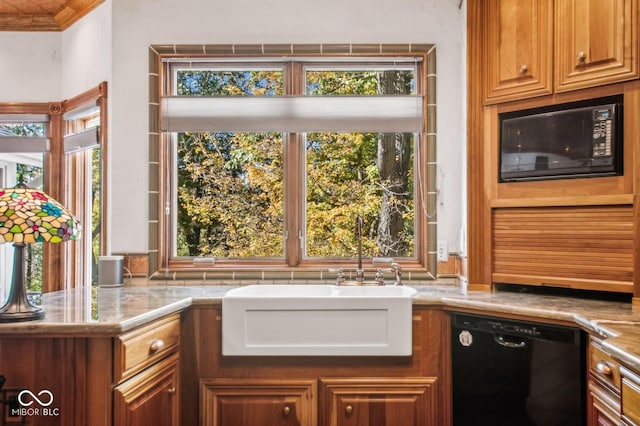 kitchen featuring light stone countertops, sink, crown molding, and black appliances