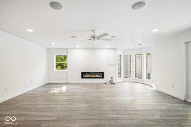 unfurnished living room with ceiling fan and light hardwood / wood-style floors