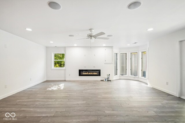 6902 Creekridge Trl, Indianapolis, IN 46256 - unfurnished living room with a glass covered fireplace, a ceiling fan, wood finished floors, recessed lighting, and baseboards