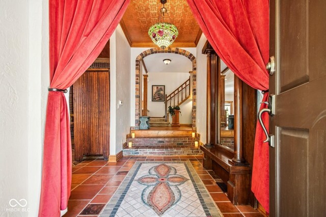 6902 Creekridge Trl, Indianapolis, IN 46256 - tiled foyer entrance featuring inlaid floor details, ornamental molding, baseboards, and stairs