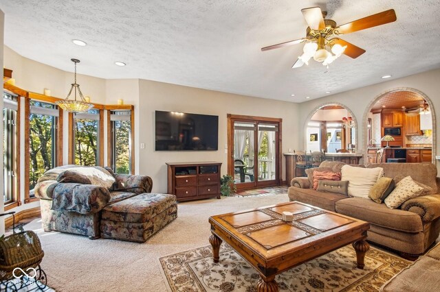 6902 Creekridge Trl, Indianapolis, IN 46256 - living area featuring a textured ceiling, light colored carpet, a ceiling fan, and recessed lighting